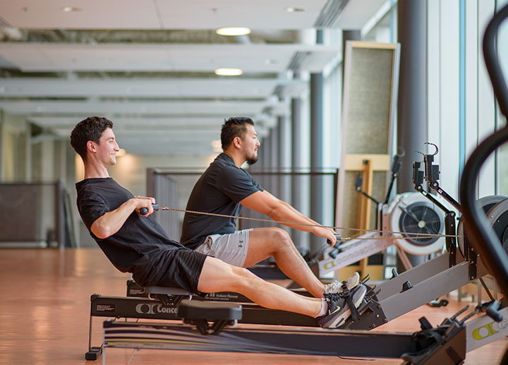 Two guy doing exercises at a recreational gym